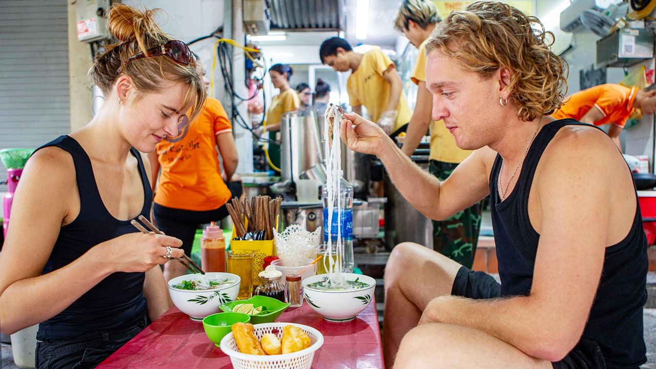 Visitors enjoy pho in the morning