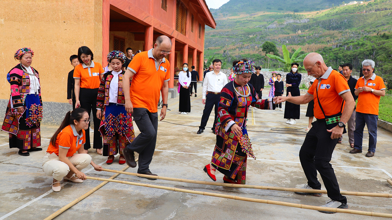 Tourists participate in Vietnamese traditions