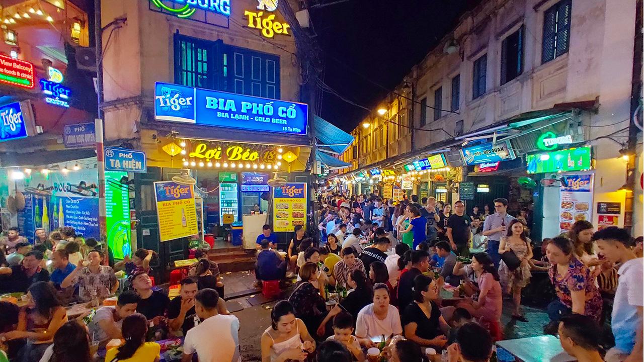 Ta Hien Street Hanoi at night with lively crowds and glowing lanterns